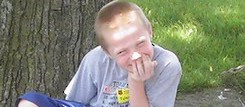 Tyler Sitting by a Tree