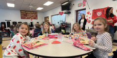 Erieview students enjoy lunch while wearing dress clothes and listening to ALHS Orchestra