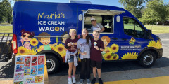 Troy students hold ice cream cones in front of Prayers from Maria Ice Cream Truck