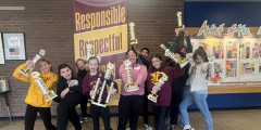 Troy Academic Challenge Team members hold up their trophies