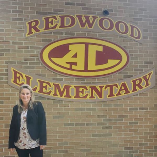Principal Holli Weber in front of Redwood School