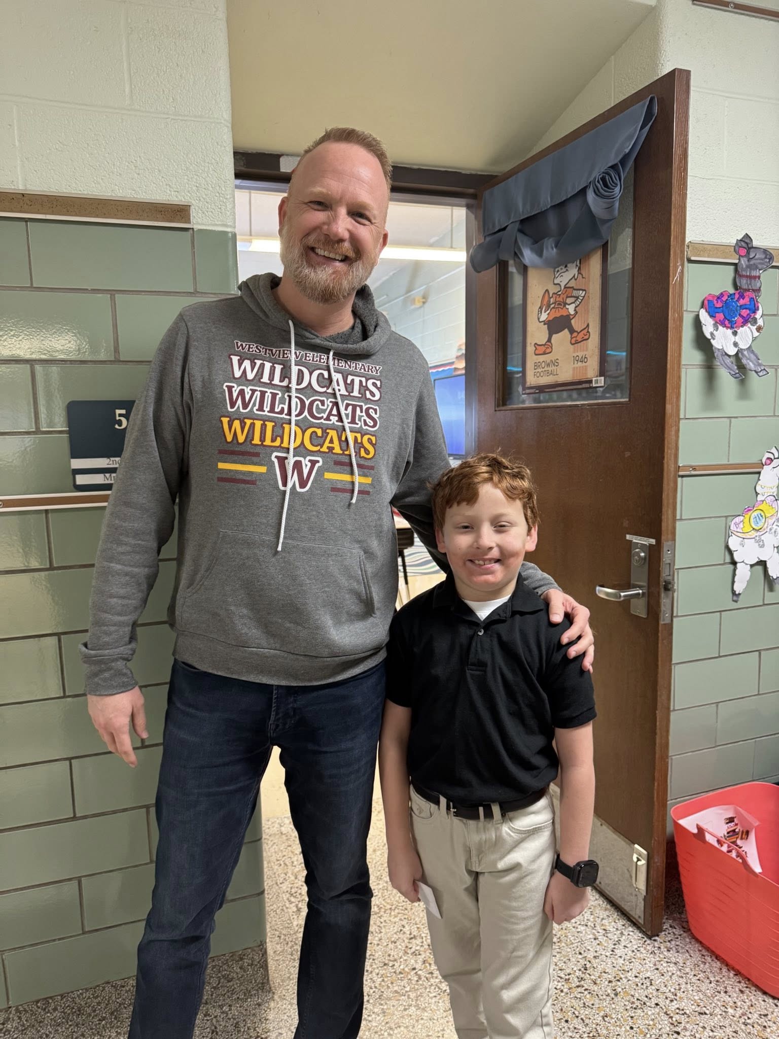 Westview teacher stands next to student with both wearing an Avon Lake hoodie and jeans
