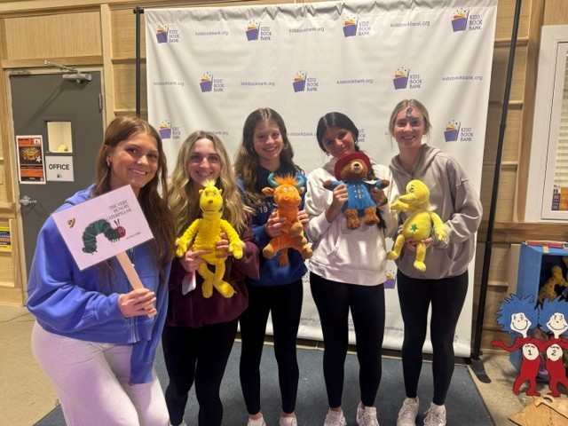 ALHS students hold up donated stuffed animals