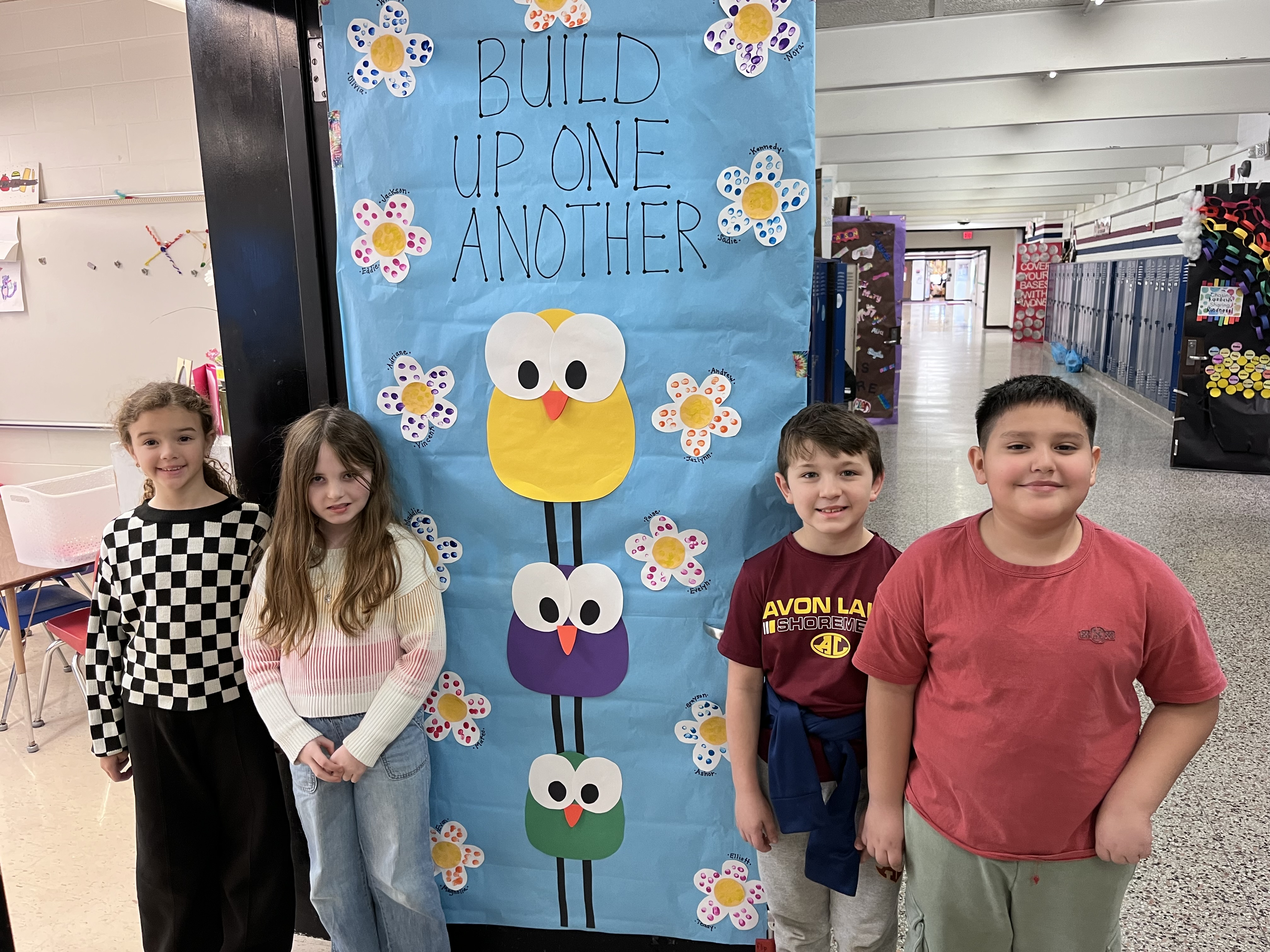 Redwood students stand outside decorated door
