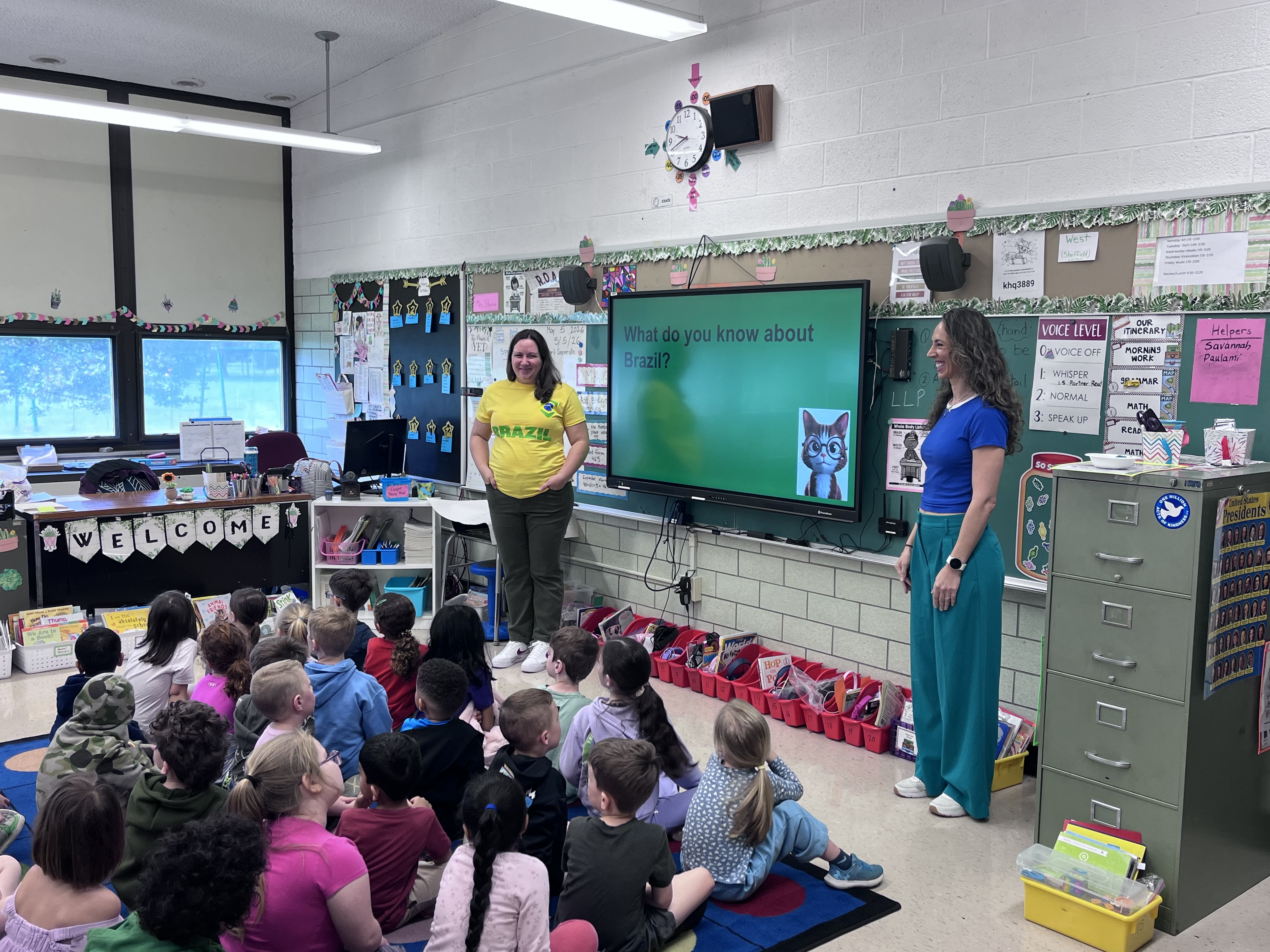 Parent volunteers present on the country of Brazil in classroom