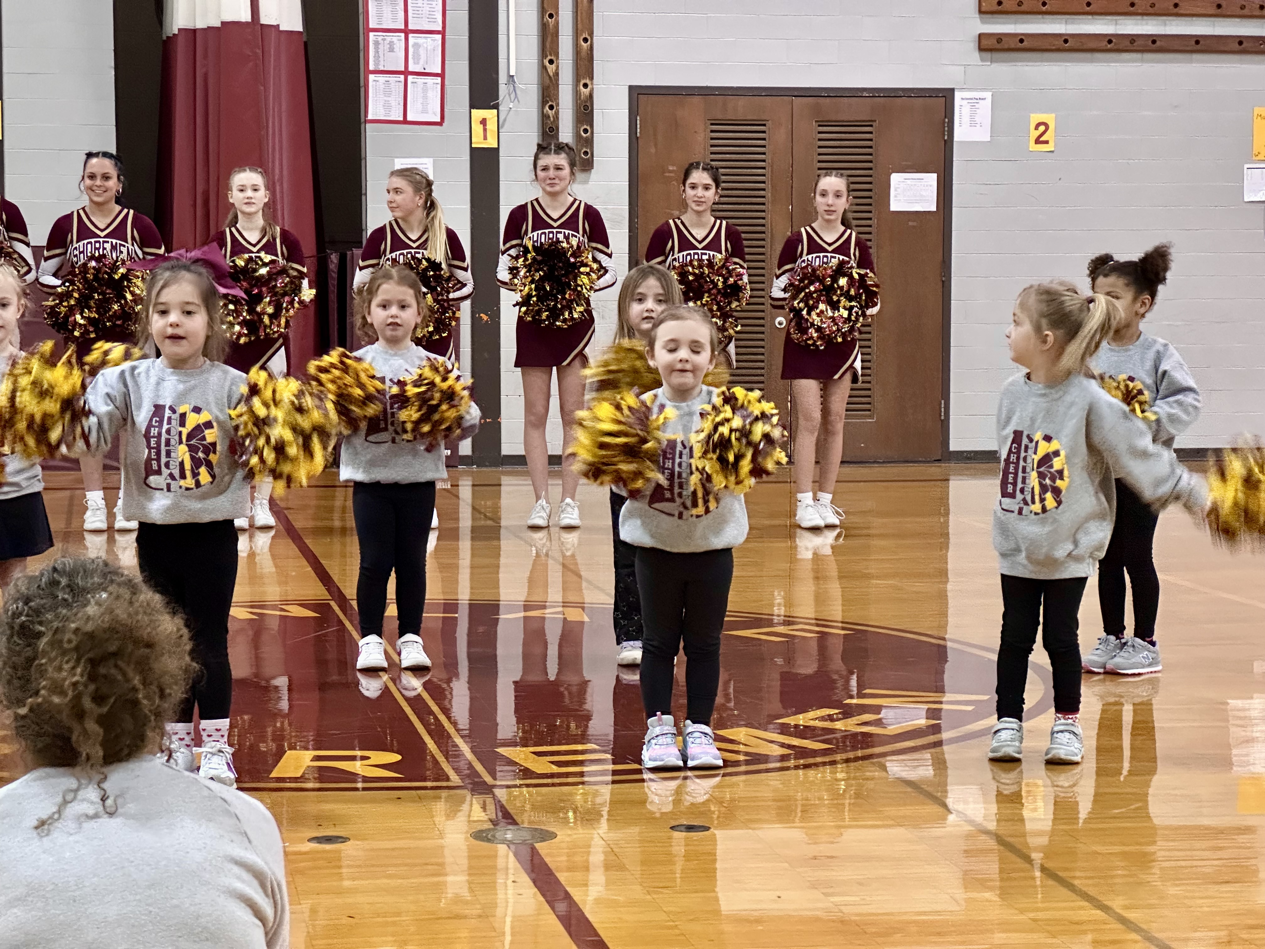 Preschool cheerleaders perform at half court
