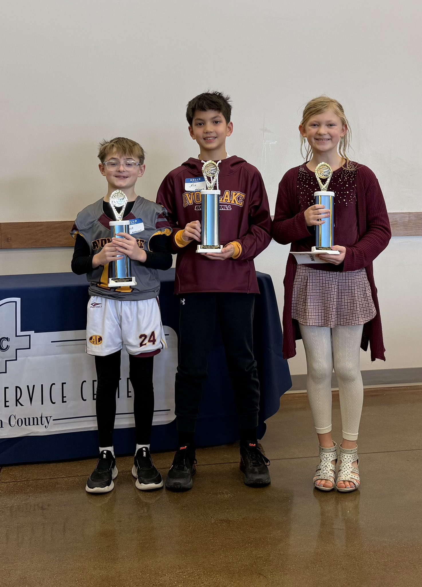 Three Westview students hold red ribbons recognizing their first place finish 